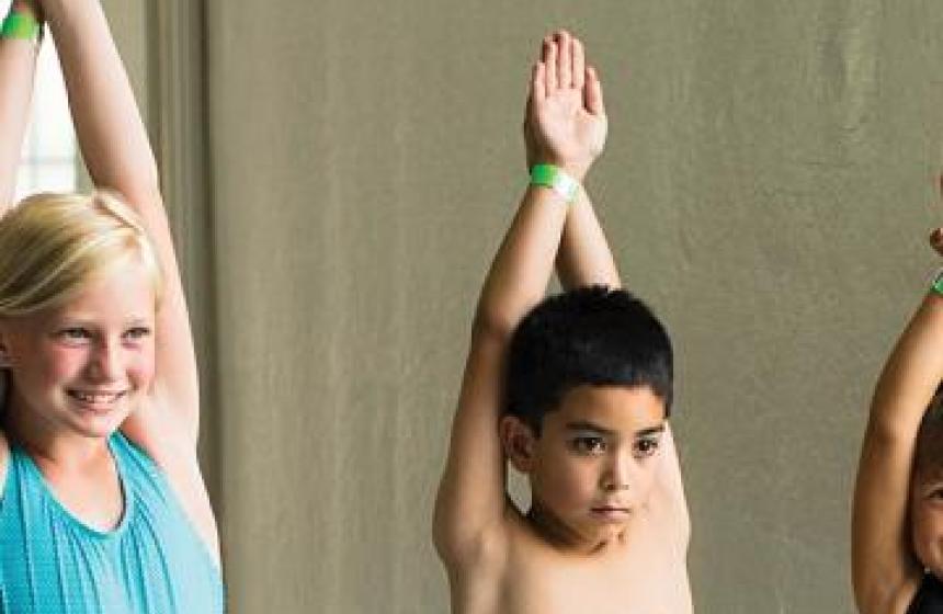 Two children practicing arm movements during a YMCA swim lesson