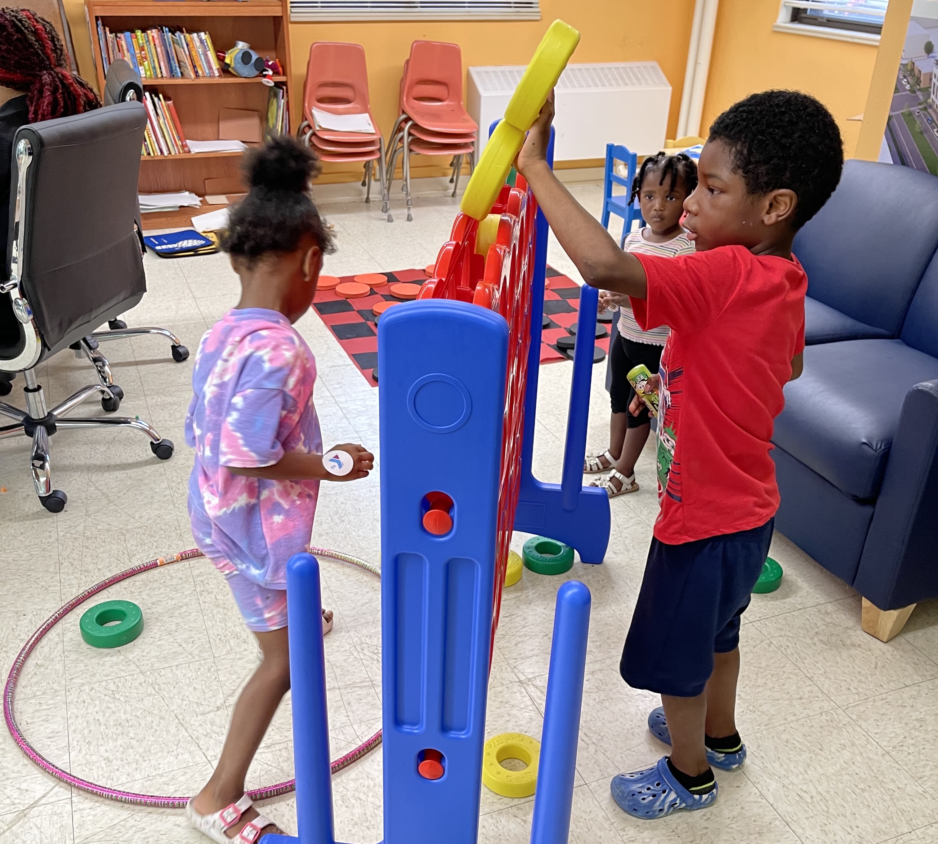 Kids playing with a giant connect 4 board