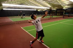 Playing tennis on indoor courts