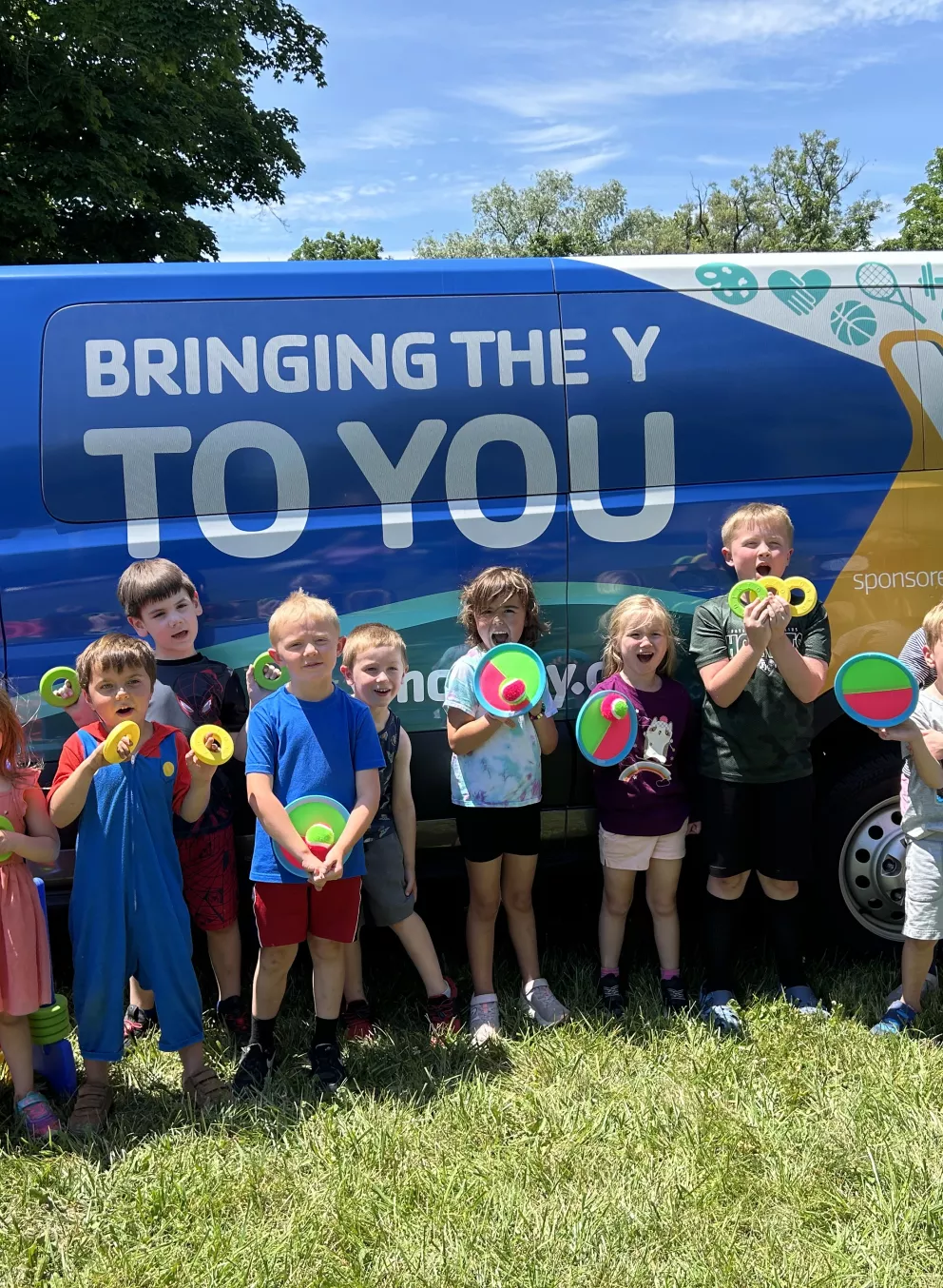 Children next to the Y on the Fly van