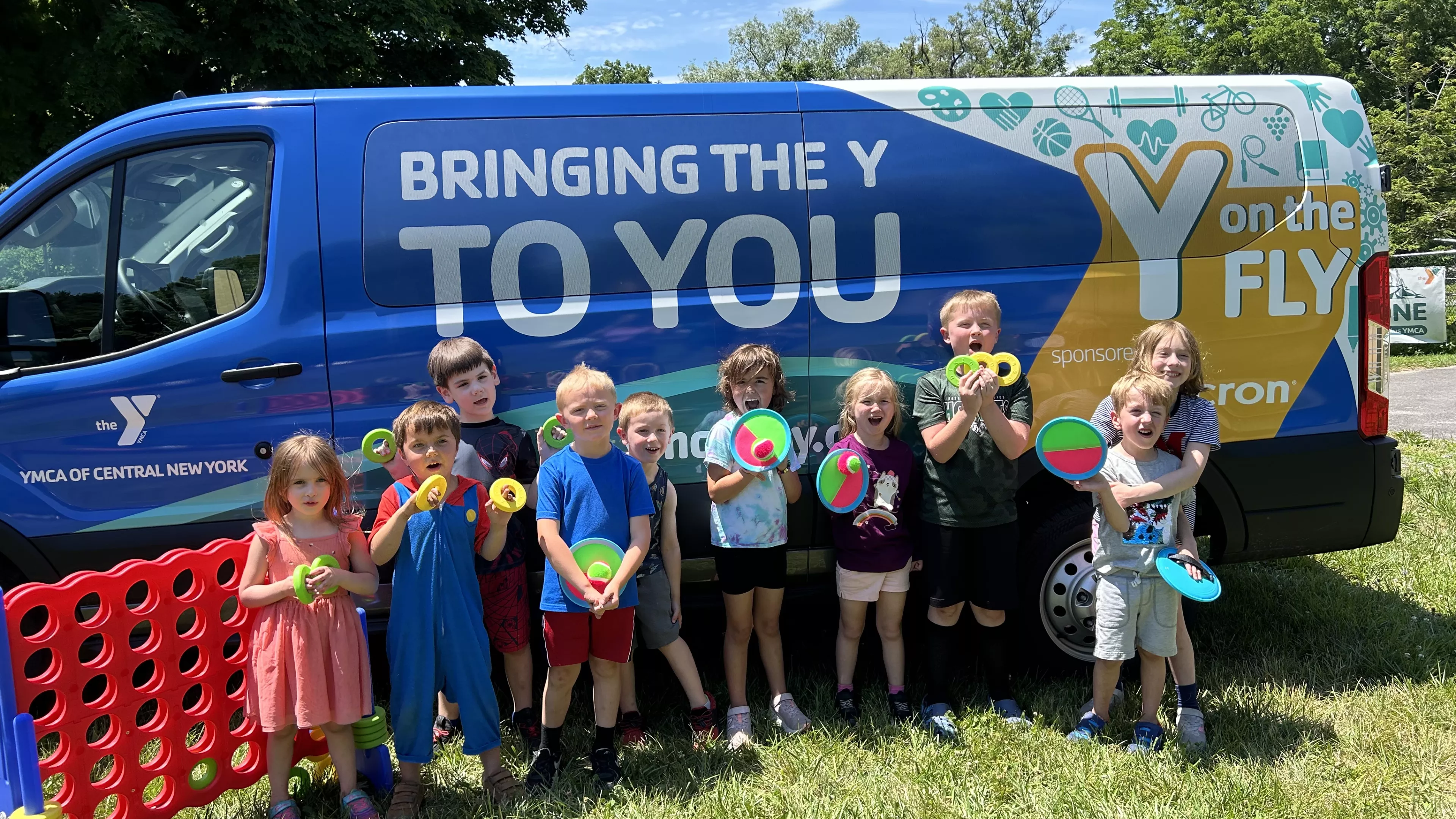 Children next to the Y on the Fly van