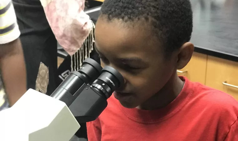 Boy with microscope