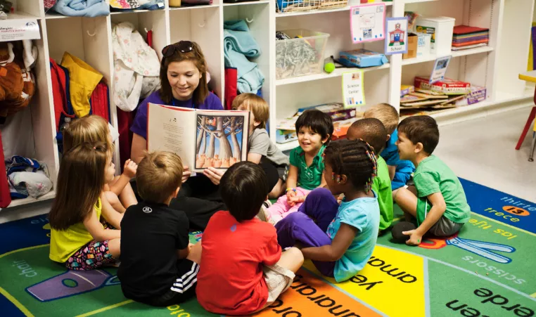 Woman reading to children