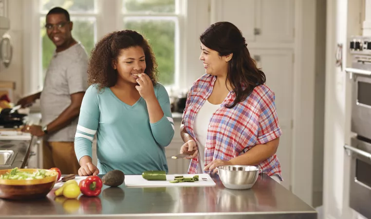 Mother and Daughter preparing food together