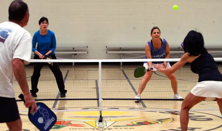 group of four playing indoor pickleball