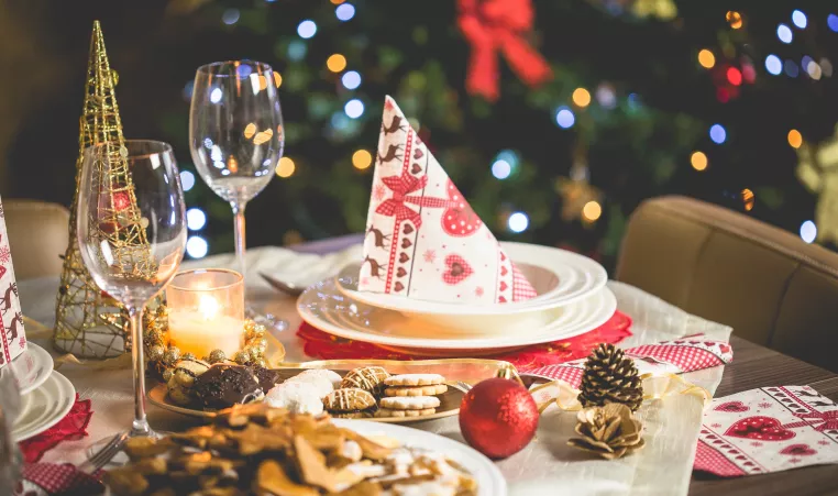 Holiday meal setting with decorative ornaments on the table