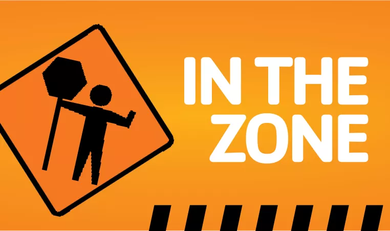 Orange construction sign that reads "In The Zone"