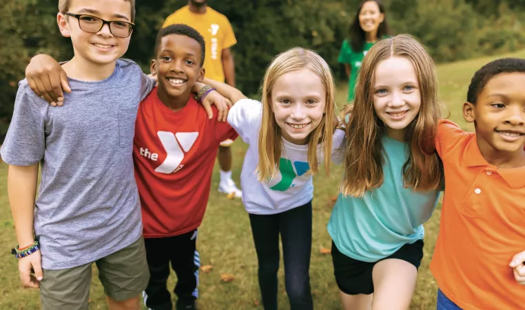 Children standing in a line with their arms around each other's shoulders