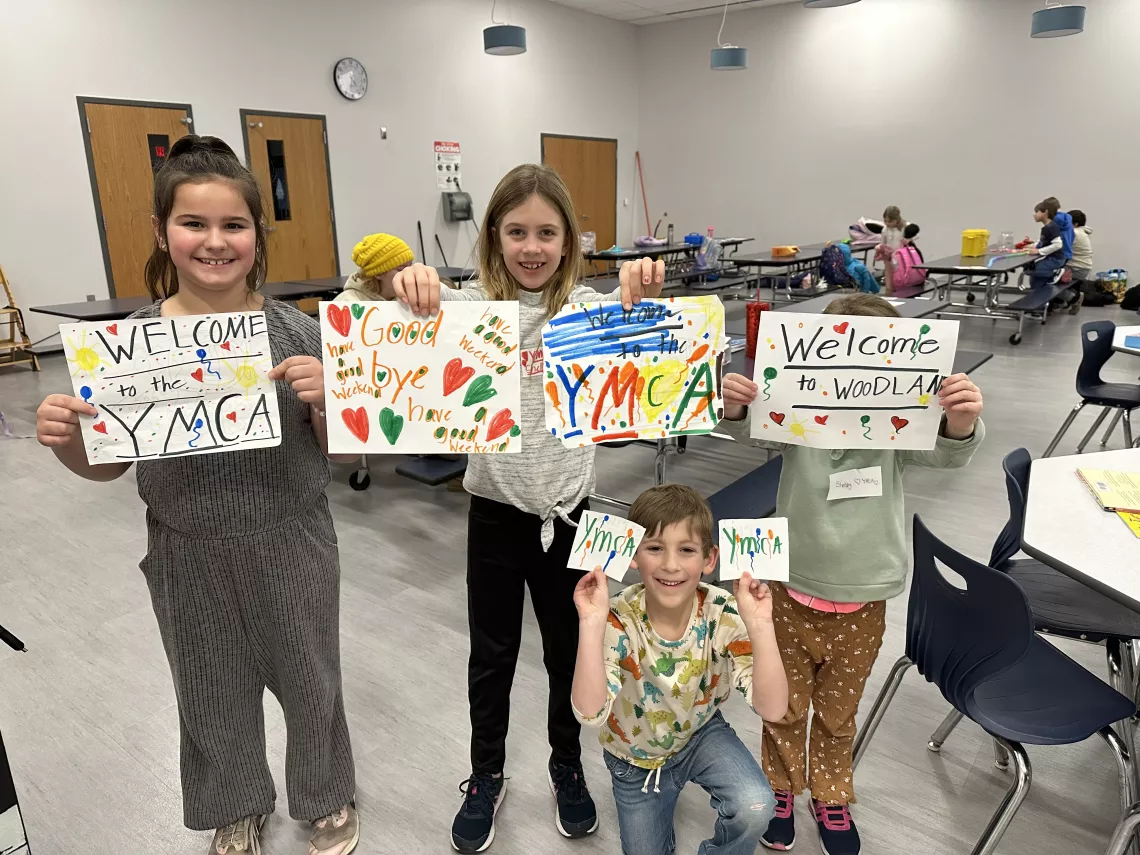 Kids holding YMCA signs
