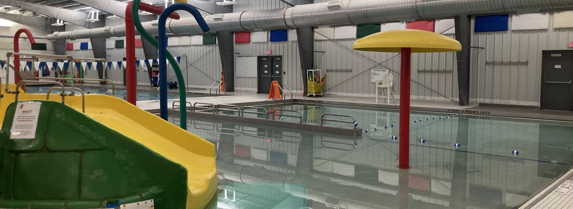 Pool area with small slide and sprinklers for kids