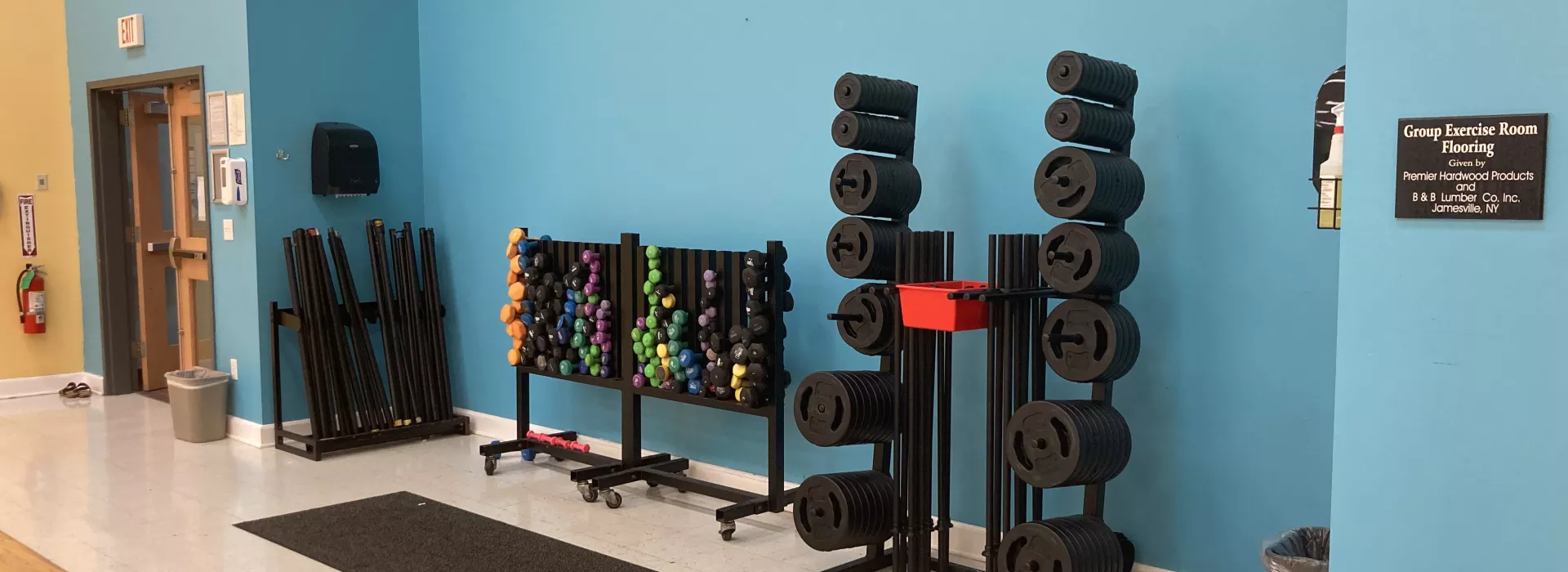 A weight rack with various different sizes and styles of weights for lifting