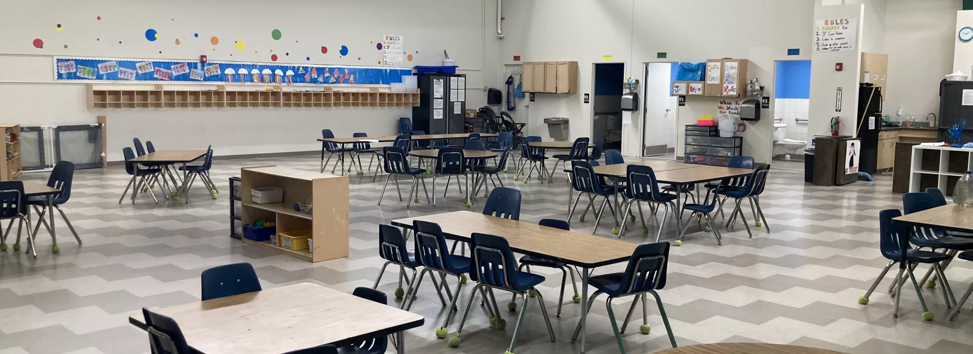 A classroom like setting designed for children with circle tables