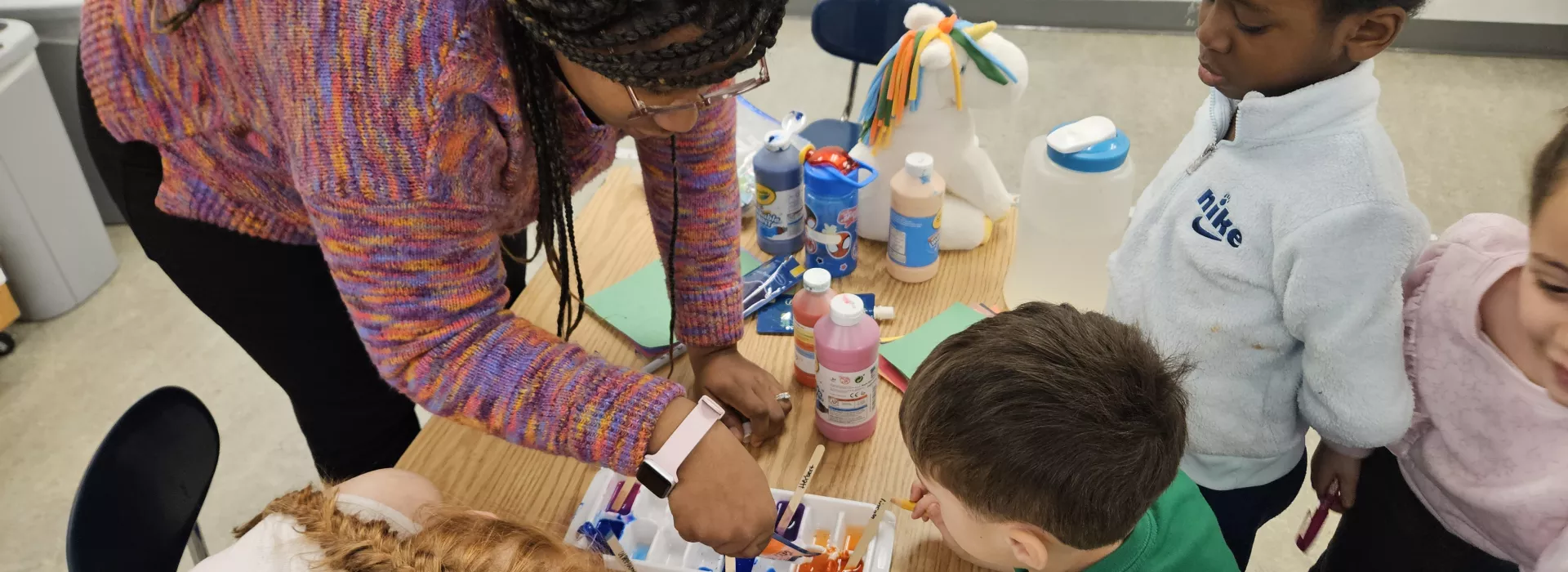 A UPK class and teacher mix paint